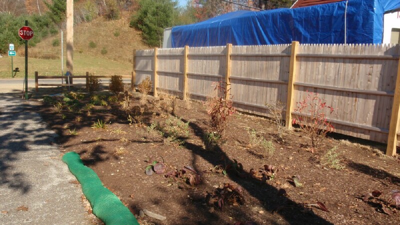 Fence along the trail with perennial garden