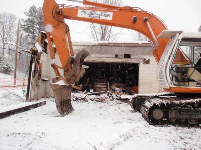Ernie's garage two sides down; concrete third side and front standing