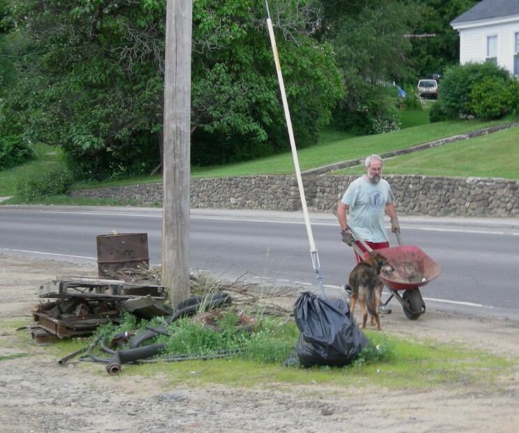 Ken and his friend help clean the site